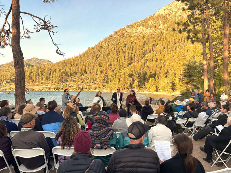 Tahoe Jewish Community Celebration of Rosh Hashana at Sand Harbor. With Lake Tahoe in the Background, Rabbi Evon and Rabbi Lauren are in front of the community who is sitting in chairs at Sand Harbor.